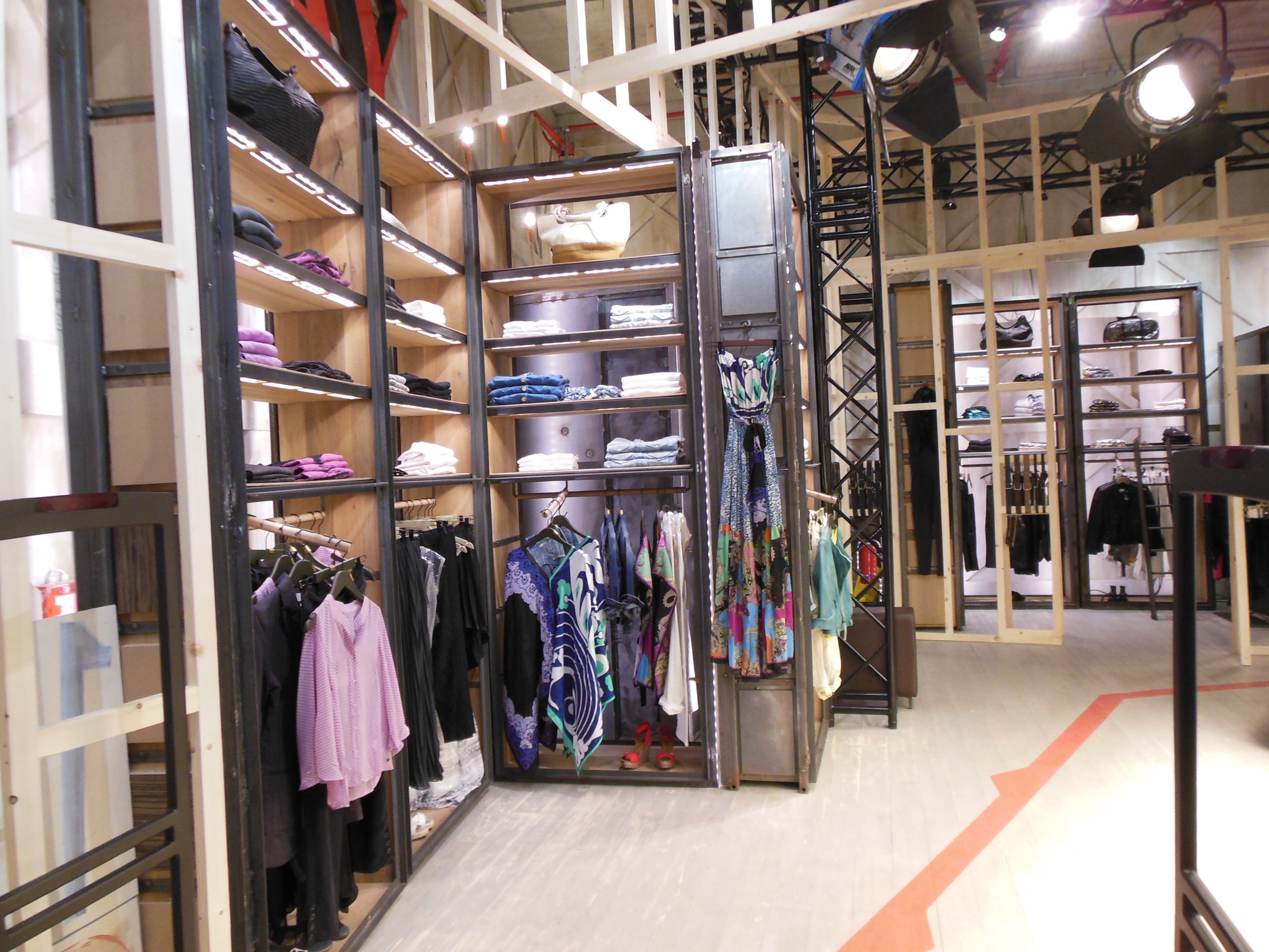 Completed Replay Milano Temporary interior with theatrical lighting and reused fixtures